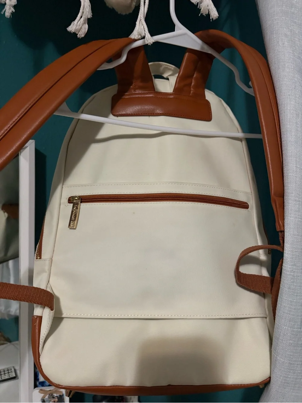 The Honest Company cream backpack